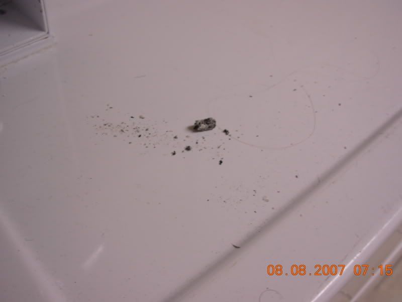 Cigarette ash on dryer in laundry room