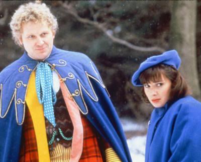 The Sixth Doctor and Peri Brown wearing the blue cloaks on mourning on Necros in Revelation of the Daleks