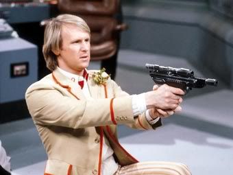 The Fifth Doctor using a gun