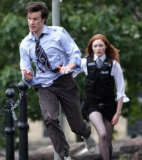 The Eleventh Doctor in tatty clothes followed by Amy Pond