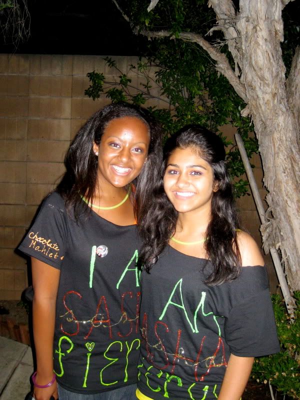 Seniors Reva Bhatt and Mahlet Yared model their personalized concert shirts. Photo courtesy of Misrak Dubale.